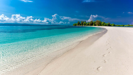 Footprints right on the very sunny beach.