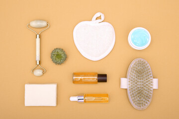 Fototapeta na wymiar Flat lay of cosmetic products on an orange background. The concept of face and body care. View from above.