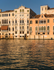 Naklejka premium Colorful architectural details and gothic Venetian Architecture in Venice, Italy by a canal