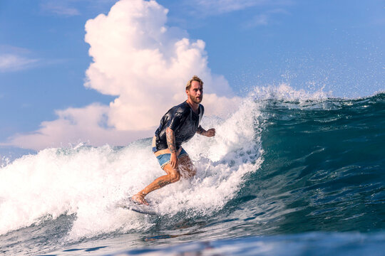 Man surfing in sea against sky