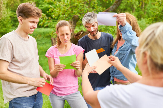 Group of people in team building with colorful cards