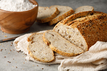 Sliced rustic multigrain bread on a towel, close up