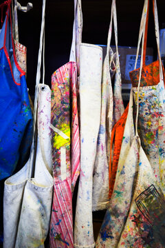 Hanging paint splattered aprons.