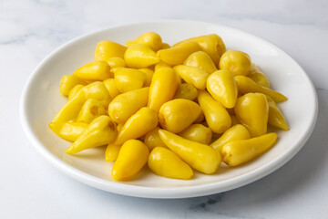 Fresh yellow chubby hot pepper pickle isolated on white background, marinated or canned peppers