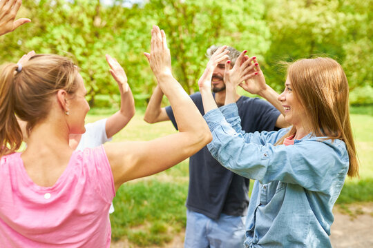 Group of young people have fun giving high five