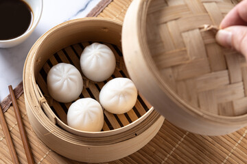 Steamed dumplings on white marble background. Traditional oriental food