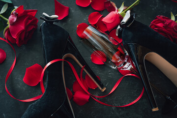 Romantic valentines day rendezvous with red roses and black stilettos. Background for love and...
