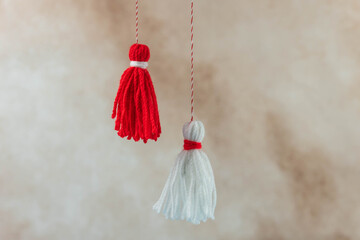 Traditional Martisor - symbol of holiday 1 March, Martenitsa, Baba Marta, beginning of spring and seasons changing in Romania, Bulgaria, Moldova. Greeting and post card for holidays.