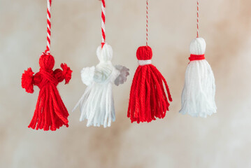 Traditional Martisor - symbol of holiday 1 March, Martenitsa, Baba Marta, beginning of spring and seasons changing in Romania, Bulgaria, Moldova. Greeting and post card for holidays.