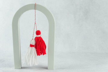 Traditional Martisor - symbol of holiday 1 March, Martenitsa, Baba Marta, beginning of spring and seasons changing in Romania, Bulgaria, Moldova. Greeting and post card for holidays.