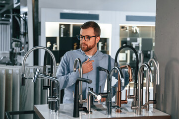 Man chooses a products in a sanitary ware store