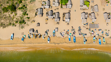 Wooden houses in a fishing village on the ocean coastline. Sri Lanka.