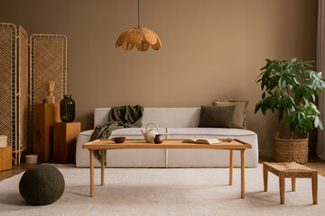 Warm and cozy composition of living room interior with modular sofa, wooden coffee table, rattan...