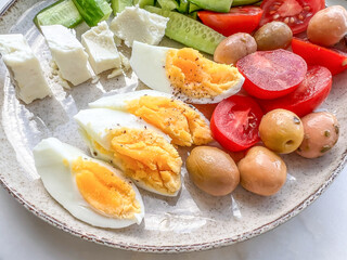 breakfast plate with slices of boiled egg and salad