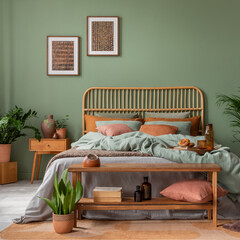 Stylish bedroom interior design with mock up poster frame, bamboo bed, night table, plants, folding...