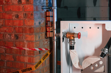 Bomb is planted near fire hose. Explosive is indoors. Police investigation. Conception of terror