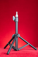 light stand for photography on red background at vertical composition