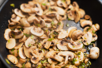 Cook champignon mushrooms in a pan with a dill