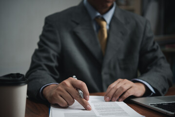 businessman agree to make deal signing document, sale contract or legal transaction contract at desk.