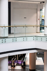 multi-level modern light interior in a shopping center with an escalator. view from above