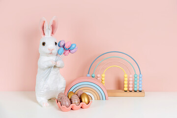 Easter Bunny and eggs on pink background. Home interior with easter decor.   Children's room in the...