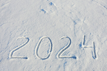 new year 2024. figures in the snow. background for winter holidays.