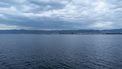 Oil refinery plant. Petrochemical factory and merchant ships in Gulf of Kocaeli Izmit Turkey. Factory causing environmental disaster with chemical gas. Noise and grain included. Selective focus