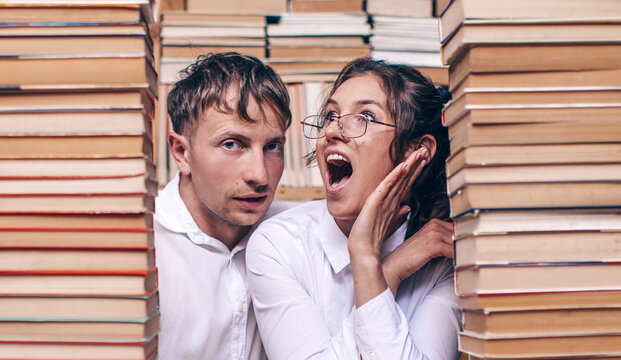 couple sitting on a bench and reading a book