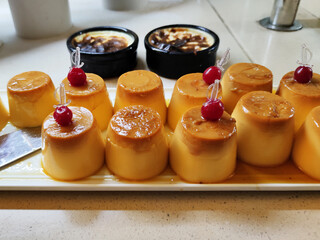 egg dessert pudding with cherry decor close-up