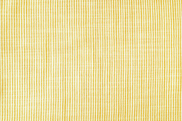 Natural linen texture as background. Cotton fabric with yellow and white line striped pattern, texture close up, top vies, flat lay. Backdrop, wallpaper. Matereal for clothes, curtain and upholstery