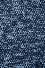 Knitted background. Texture of knitted woolen fabric close up.