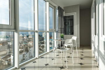 large spacious glazed balcony loggia in the apartment with a gorgeous view of the sunny city