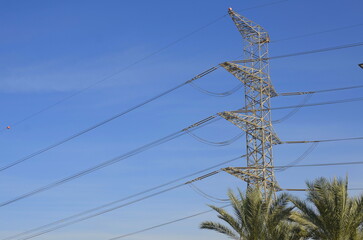 High voltage pole on blue sky background