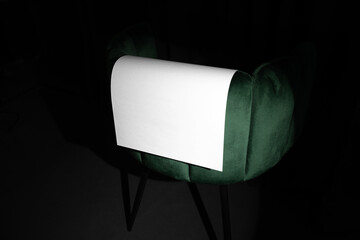 Blank poster mockup template on a velvet, green art deco furniture. Real photo, isolated surface to...