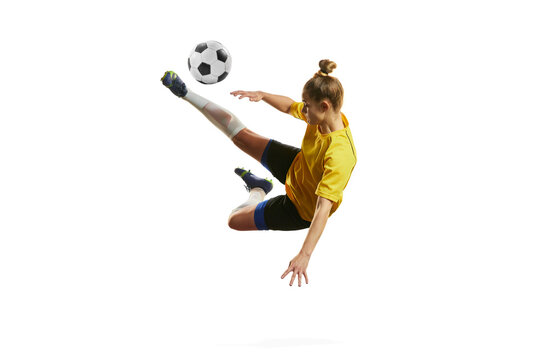 Hitting and falling down. Young professional female football, soccer player in motion, training, playing isolated over white background