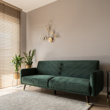 Elegant green sofa in living room
