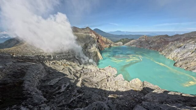 Dive to volcano crater island mountain crack stone sharp structure with acid lake turquoise blue water and miss fog aerial view. FPV sport drone shot geology formation pond cliff rocky terrain nature