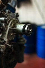 Detail view of a removed V8 engine in a vintage car workshop