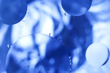 Oil bubbles close up. circles of water macro. abstract light blue background