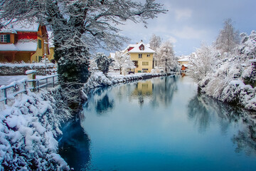 Interlaken landscape after snow in winter with river reflection, Swiss alps