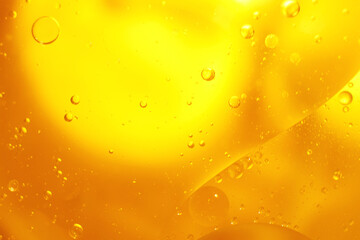 Gold Oil bubbles close up. circles of orange water macro. abstract shiny yellow background