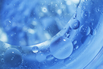 Oil bubbles close up. circles of water macro. abstract light blue background