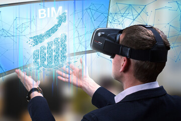 Business, Technology, Internet and network concept. Young businessman working on a virtual screen of the future and sees the inscription: BIM