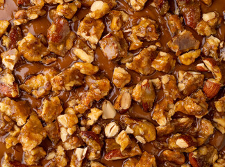 Closeup of almond and walnut praline cheesecake topping
