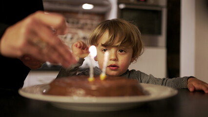 Mother celebrating toddler son birthday, child celebrates two years of age, happy parent with her son2