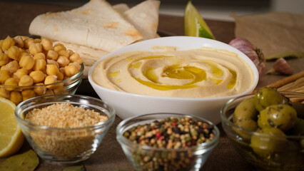 Hummus garnished with chickpeas, olive oil, spices, paprika. Hummus or fava, a hearty snack of legumes. Kosher healthy vegan food. Lean, vegetarian dish