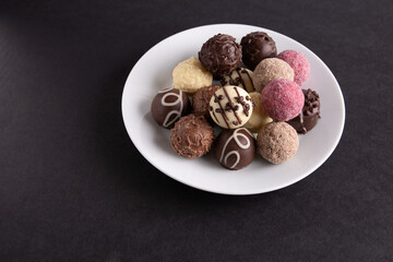 photo mix of different chocolates on a white plate