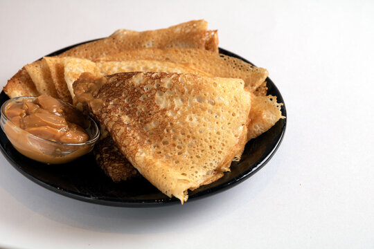 photo fried triangular pancakes with condensed milk