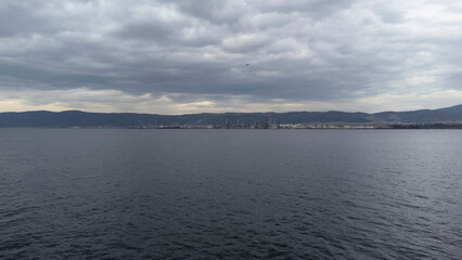 Oil refinery plant. Petrochemical factory and merchant ships in Gulf of Kocaeli Izmit Turkey. Factory causing environmental disaster with chemical gas. Noise and grain included. Selective focus
