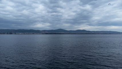 Oil refinery plant. Petrochemical factory and merchant ships in Gulf of Kocaeli Izmit Turkey. Factory causing environmental disaster with chemical gas. Noise and grain included. Selective focus